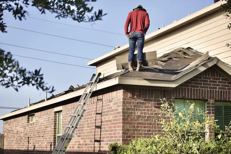 Professional roofer working on a residential roof in Sanctuary Village